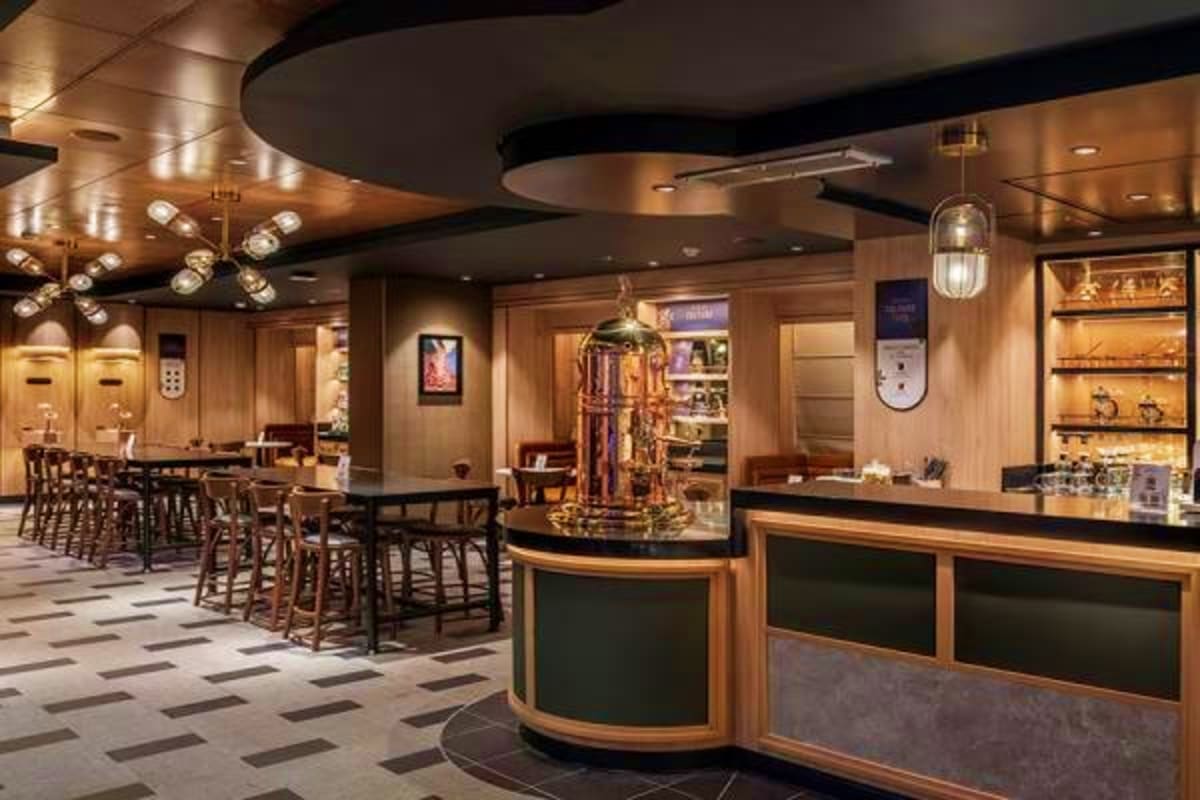 Luxury cruise ship lounge with curved black ceiling, wood paneling, bar counter, dining area with bar seating, and modern lig
