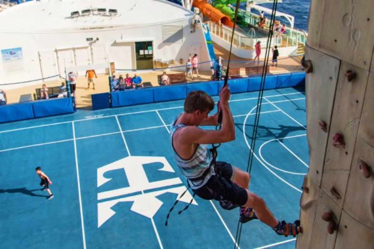 Young boy zip-lining across sports court on Royal Caribbean Liberty of the Seas cruise ship