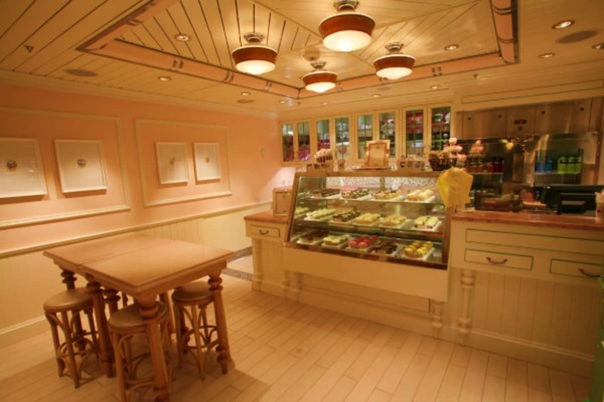 Modern bakery and pastry shop interior on Liberty of the Seas cruise ship with display cases and seating area