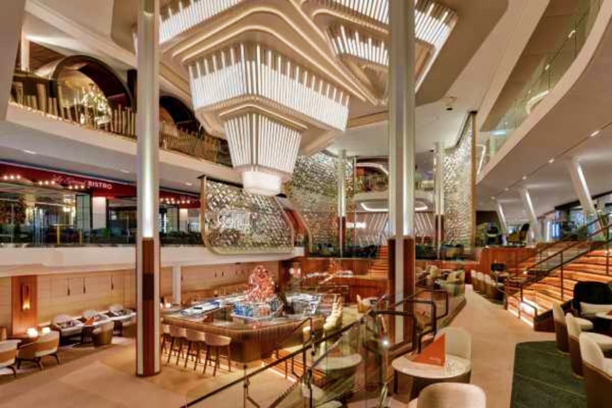 Celebrity Xcel Mediterranean Escape Modern cruise ship interior atrium with multi-level dining area, bar, skylight, and contemporary furnishings across open deck