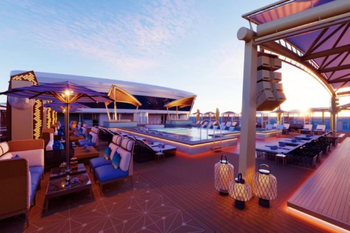 Luxury rooftop deck of cruise ship at dusk with lounge seating, pool, and illuminated pergolas overlooking the sea