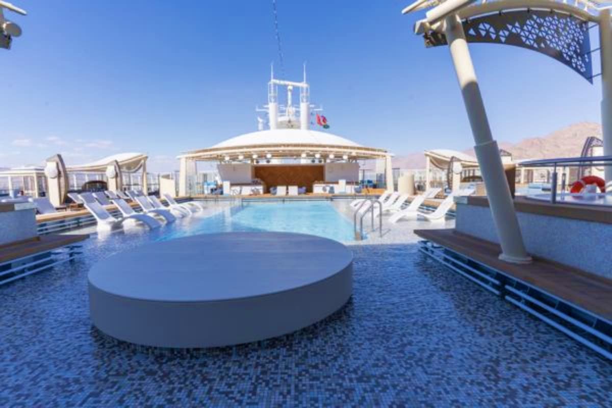 Aroya Red Sea Egypt Explorer Cruise. Cruise ship pool deck with loungers, hot tub, and covered bar area overlooking the Red Sea