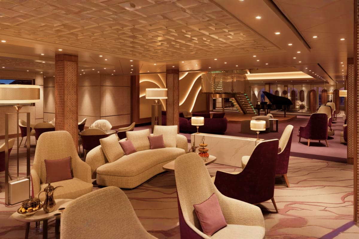 Luxury cruise ship interior lounge with cream and burgundy seating, decorative pillars, ambient lighting, and grand piano in 