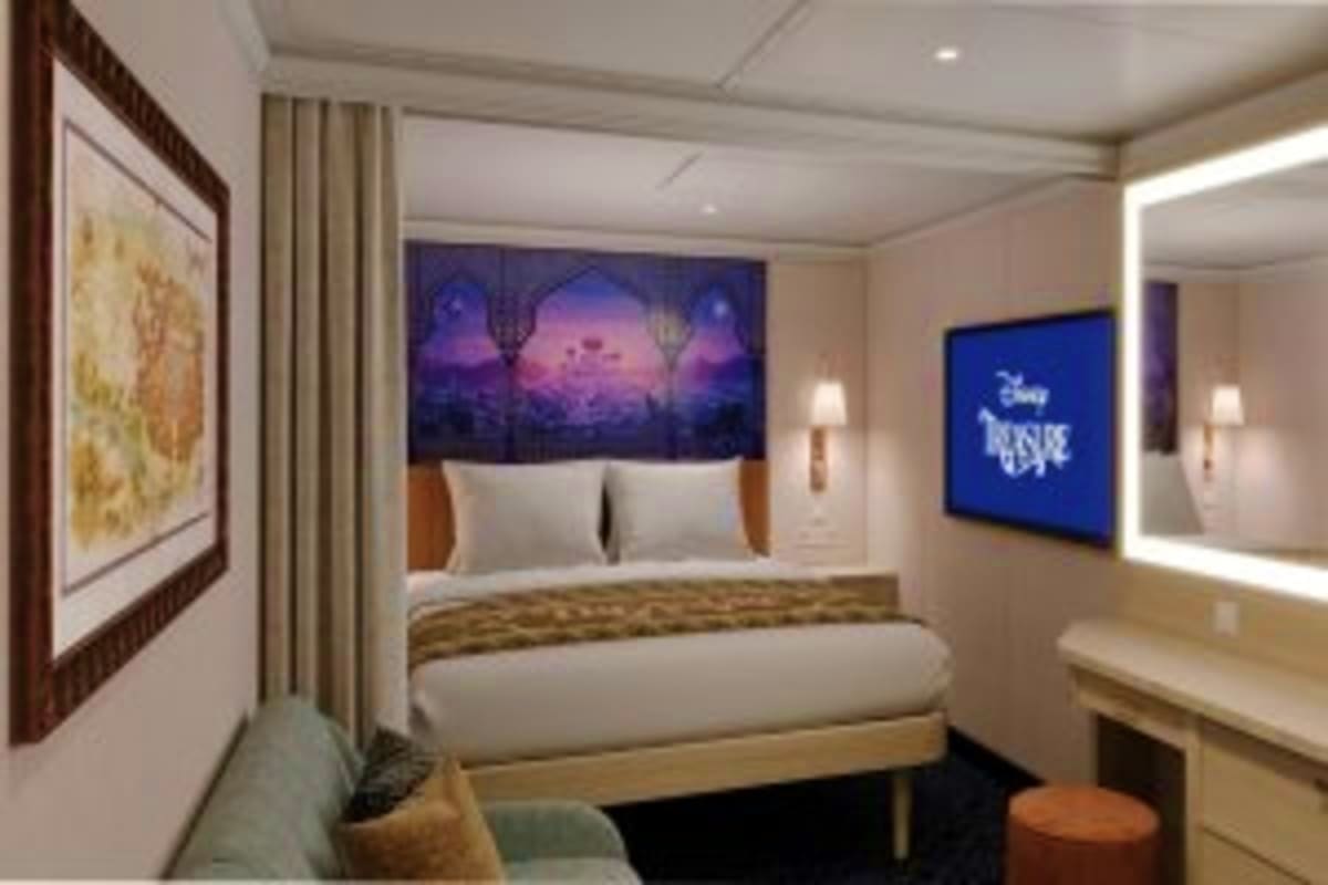 Luxury cruise ship stateroom with queen bed, purple sunset artwork above headboard, flat-screen TV, and modern furnishings