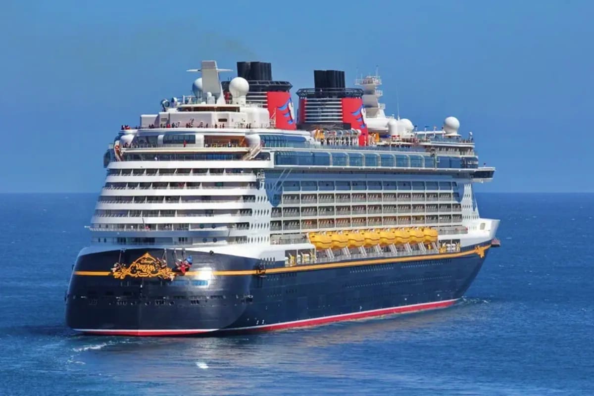 Disney Dream cruise ship anchored in blue ocean waters with clear sky