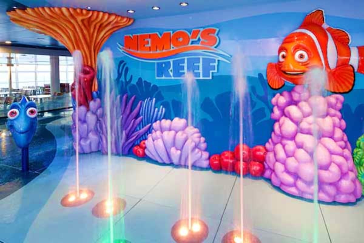 Nemo's Reef themed area on Disney Dream cruise ship with colorful underwater decor, fish characters, and illuminated floor li