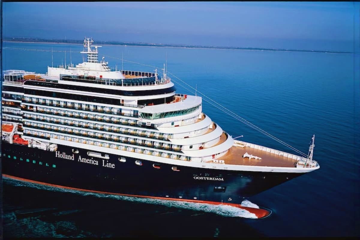 Oosterdam Mediterranean Voyage Holland America Line Oosterdam cruise ship anchored in blue Mediterranean waters with white superstructure and black hull