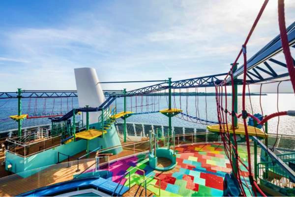 Colorful children's play area on MSC Euribia cruise ship deck with slides, climbing structures, and ocean view