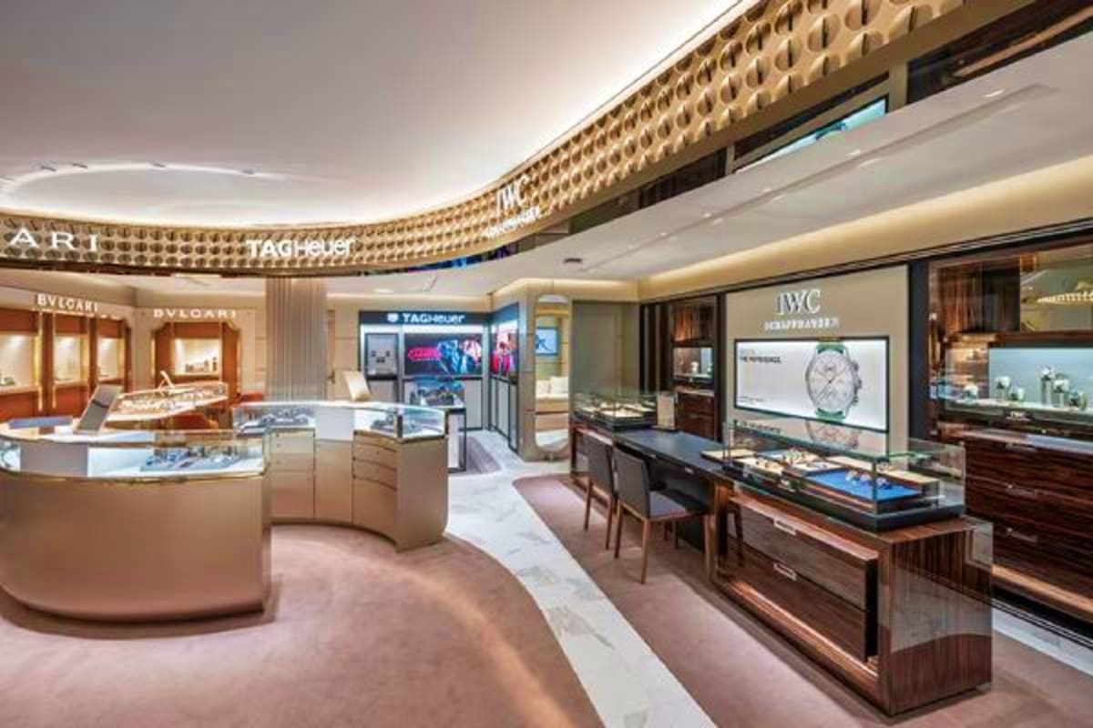 Luxury watch and jewelry boutique onboard MSC Euribia with curved display cases and illuminated brand signage