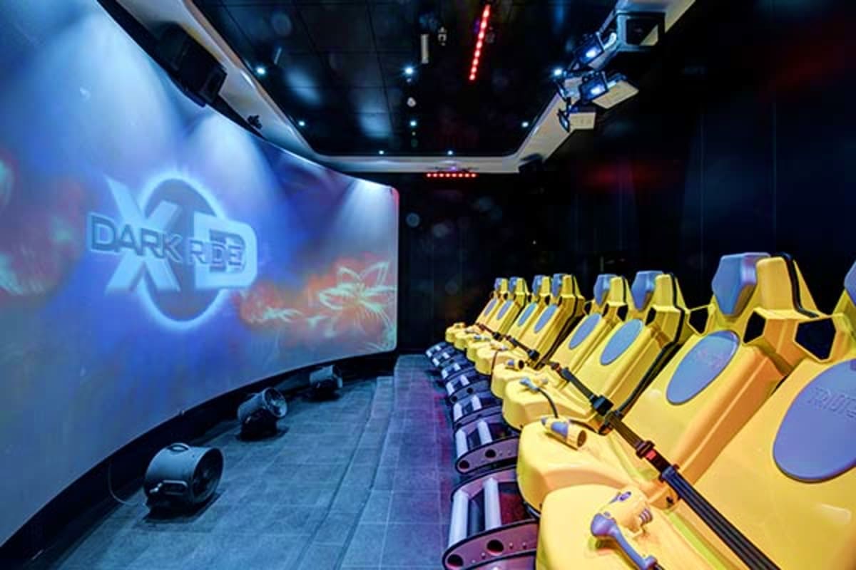 MSC Preziosa Northern Escape Dark Reef 4D motion simulator ride with yellow seats and large projection screen in entertainment venue