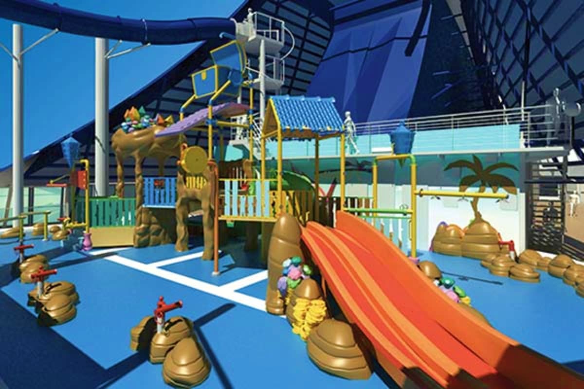 Indoor water park area with slides, climbing structures, and tropical-themed decor on MSC Preziosa cruise ship