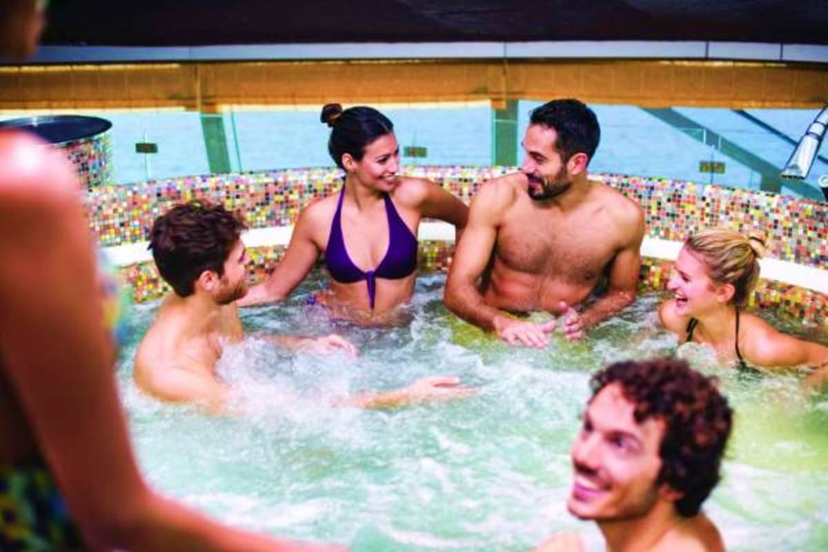Group of adults enjoying a hot tub with colorful mosaic tile walls on Costa Fascinosa cruise ship