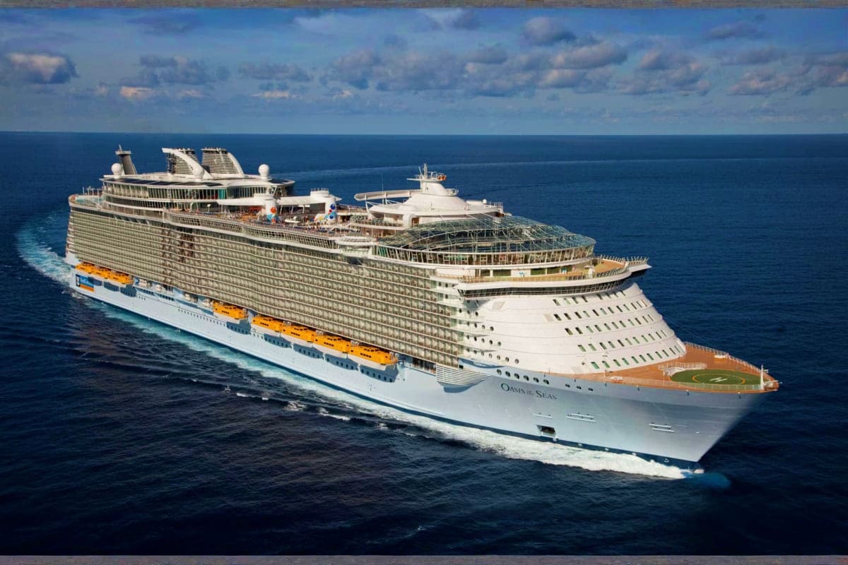 Oasis of the Seas cruise ship sailing on open ocean waters under cloudy blue sky