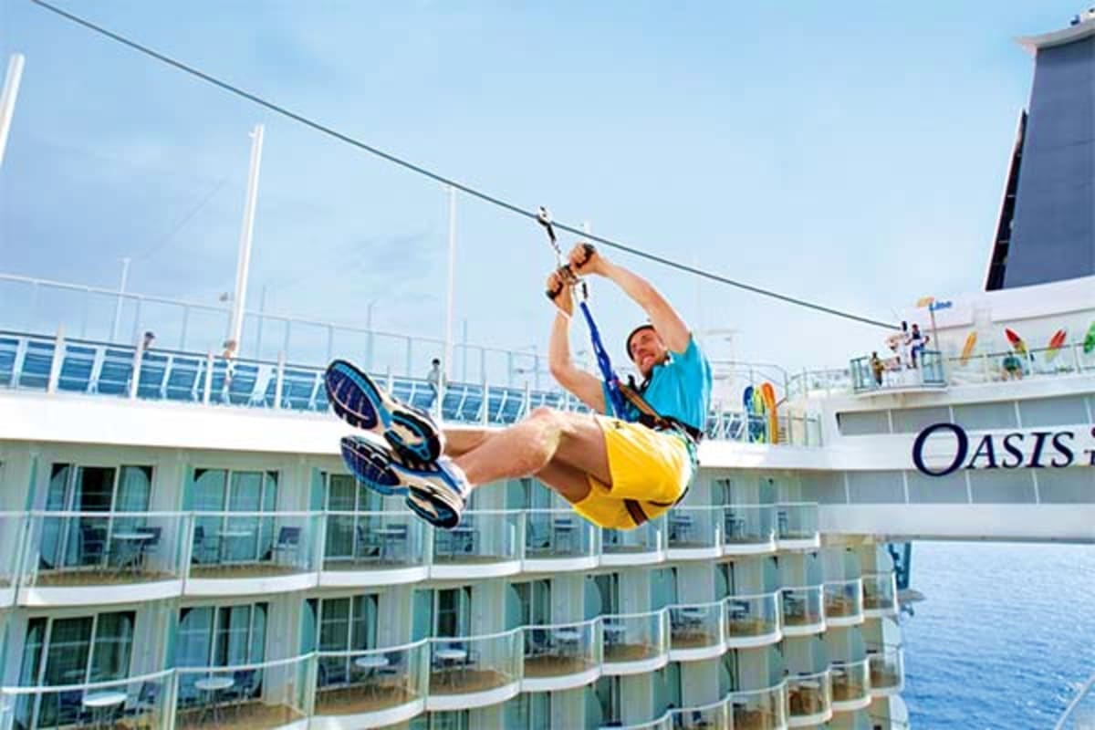 Man ziplining across deck of Oasis of the Seas cruise ship over ocean water