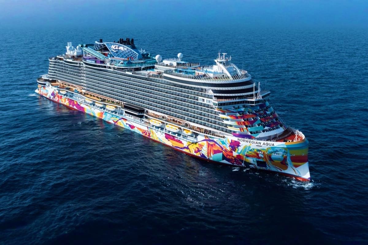 Norwegian Aqua Bermuda Escape Norwegian Aqua cruise ship at sea with colorful hull artwork and multiple decks visible on blue ocean water