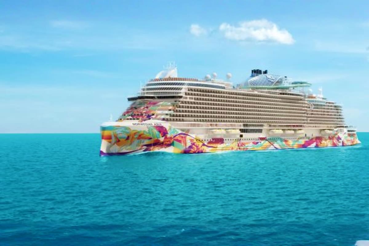 Norwegian Aqua cruise ship sailing in turquoise ocean waters under blue sky with colorful hull artwork visible from the side
