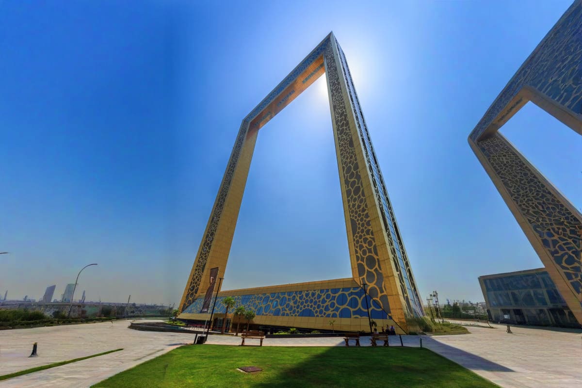 Giant ornate gold and blue frame structures at Dubai's Zabeel Park, a modern architectural landmark against clear blue sky