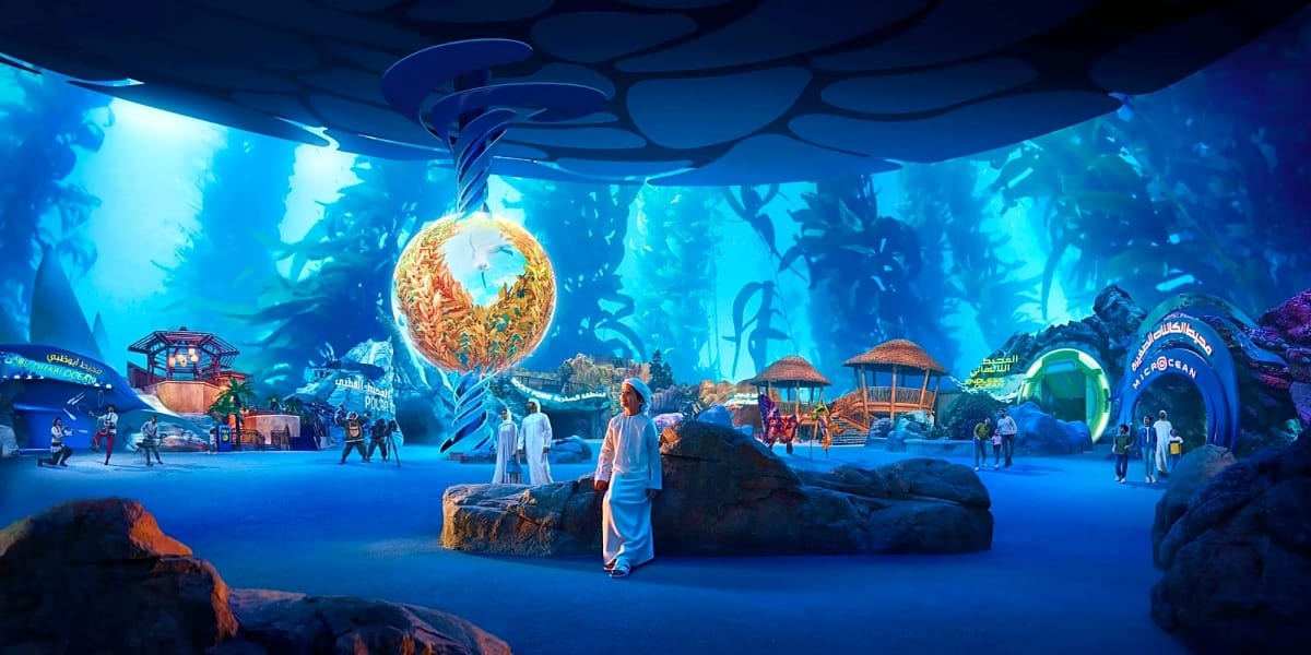 Immersive underwater-themed attraction in Abu Dhabi with glowing golden sphere, Arabic architecture, visitors exploring blue-