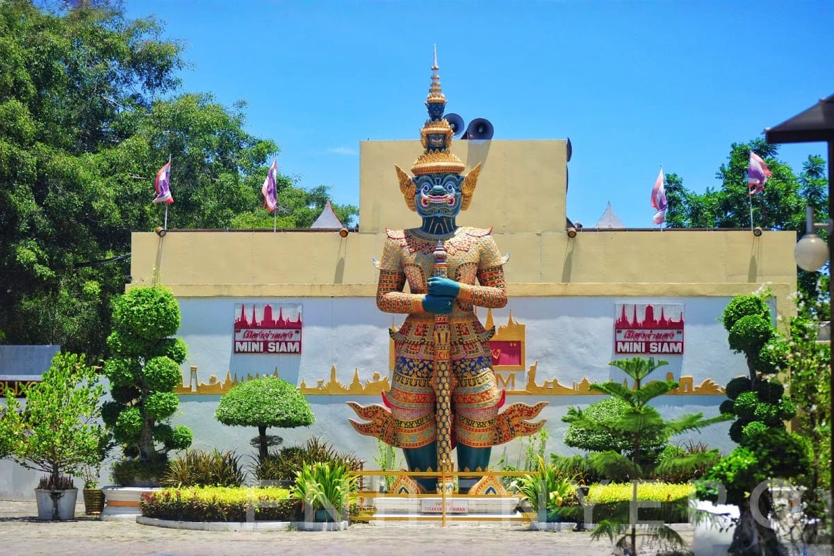 Giant golden demon statue with ornate Thai costume at Mini Siam theme park entrance in Pattaya, Thailand