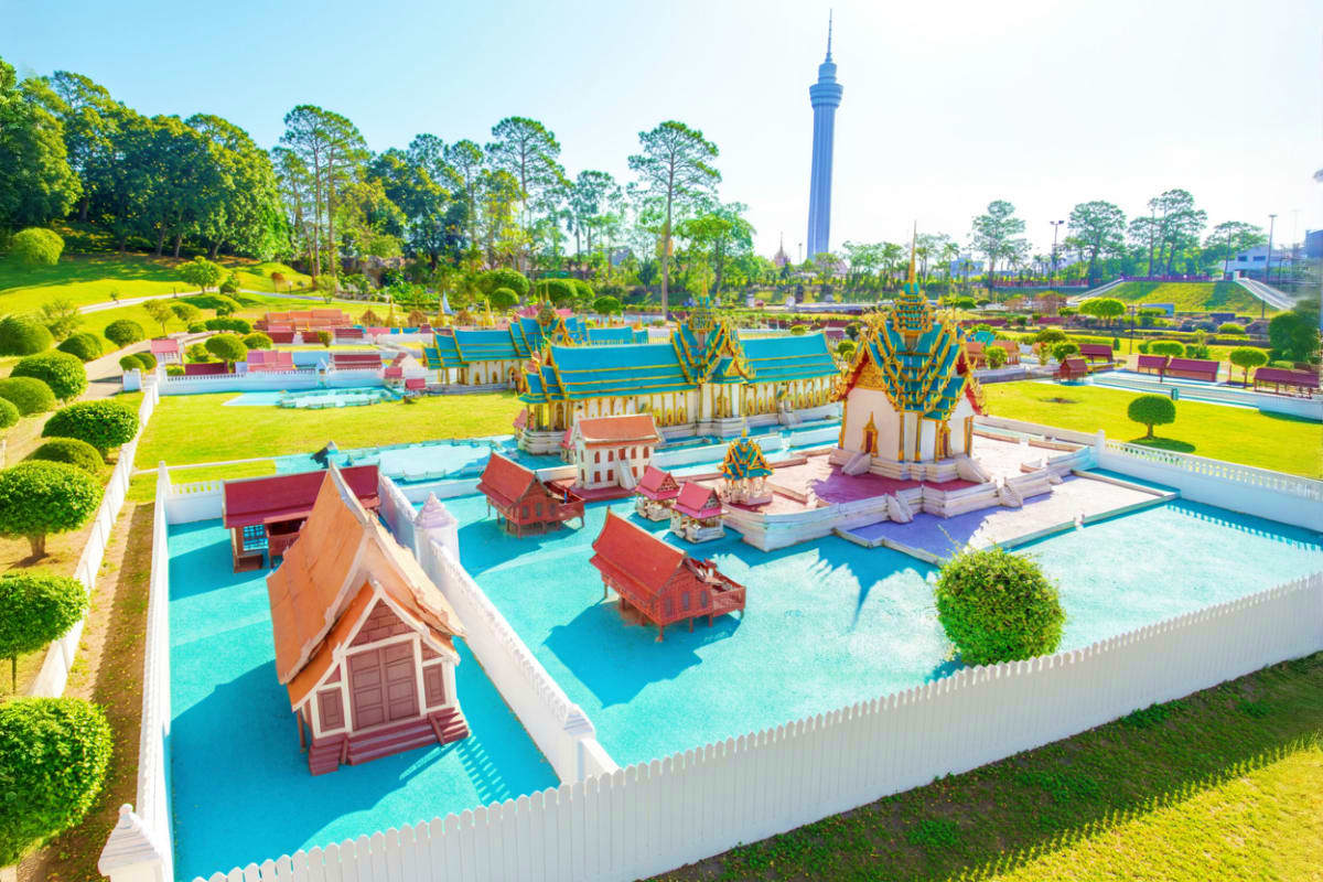 Aerial view of Mini Siam theme park in Pattaya showing colorful miniature Thai temple buildings with blue roofs and turquoise