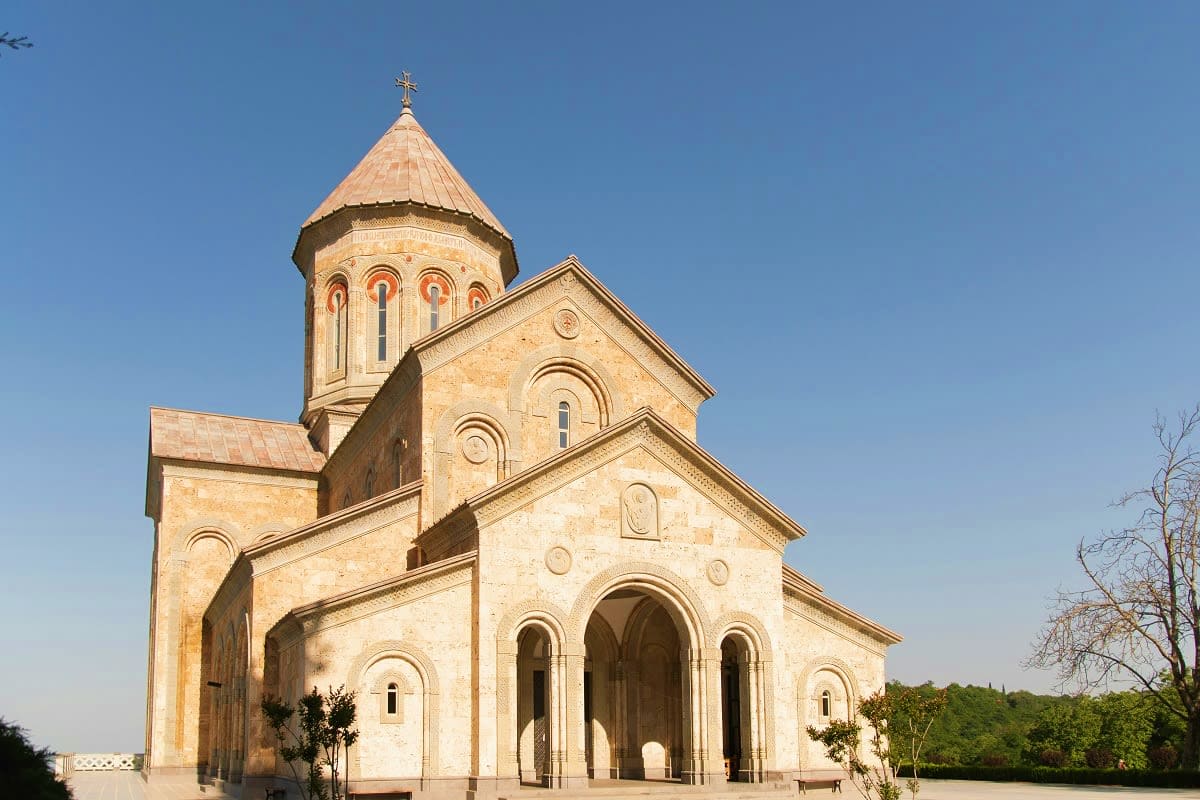 Orthodox church with golden dome and cross in Kakheti wine region, Georgia, against clear blue sky