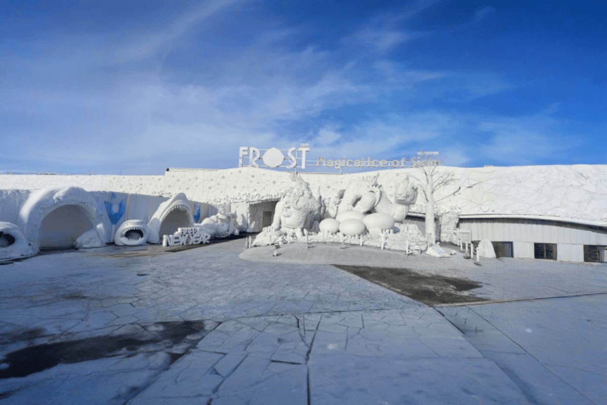 Exterior view of Frost Magic ice sculpture attraction in Pattaya with white frozen structures and signage against blue sky