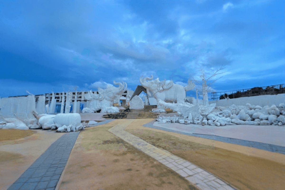 Construction site with white stone sculptures and elephant statues under blue sky at Frost Magic Pattaya theme park