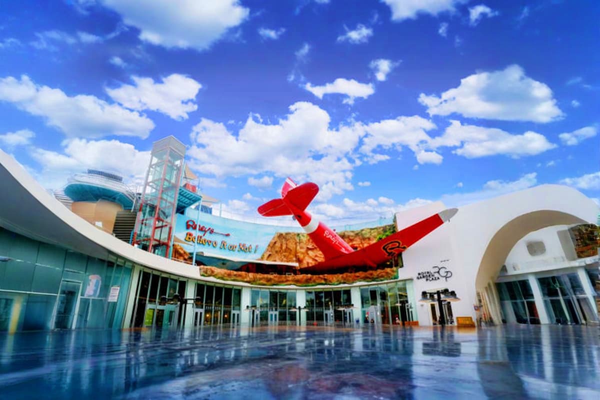 Ripley's Believe It or Not museum exterior with red airplane sculpture, modern white building architecture, and blue sky with