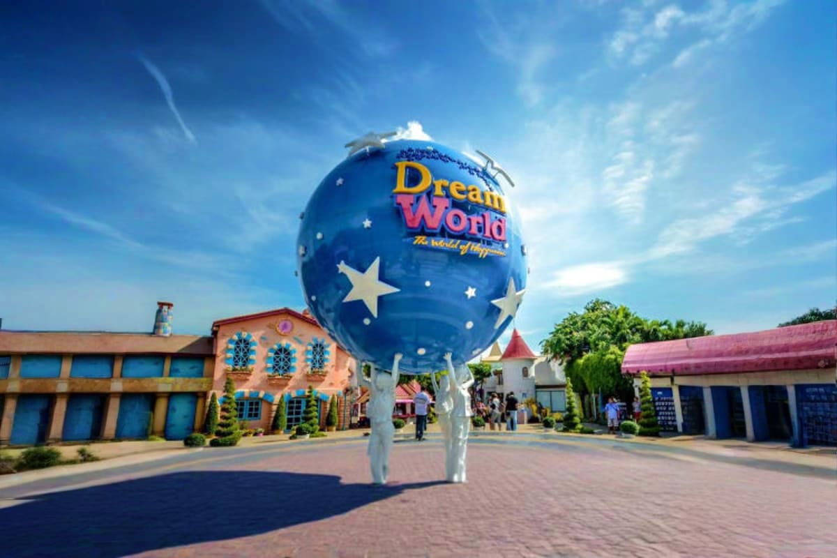 Giant blue Dream World balloon landmark with stars at theme park entrance during daytime