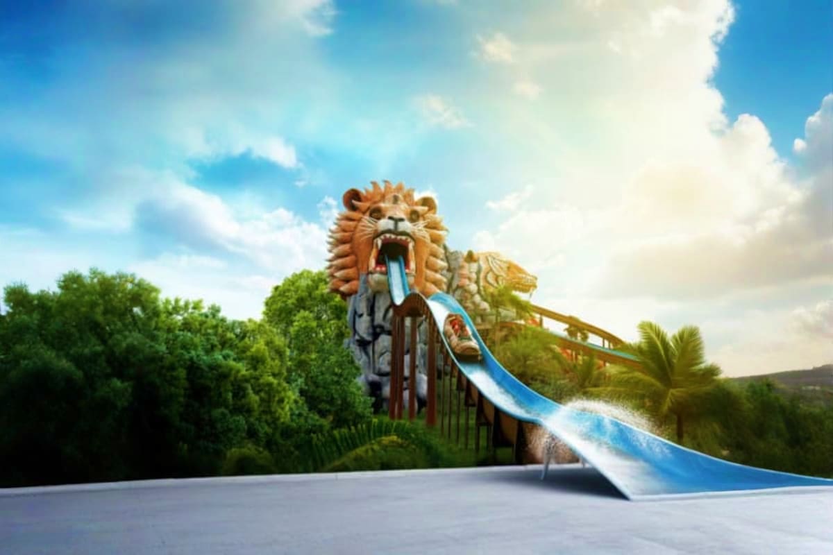 Siam Amazing Park Bangkok Lion-shaped water slide at Siam Amazing Park with blue slide descending from roaring lion head sculpture surrounded by tropic