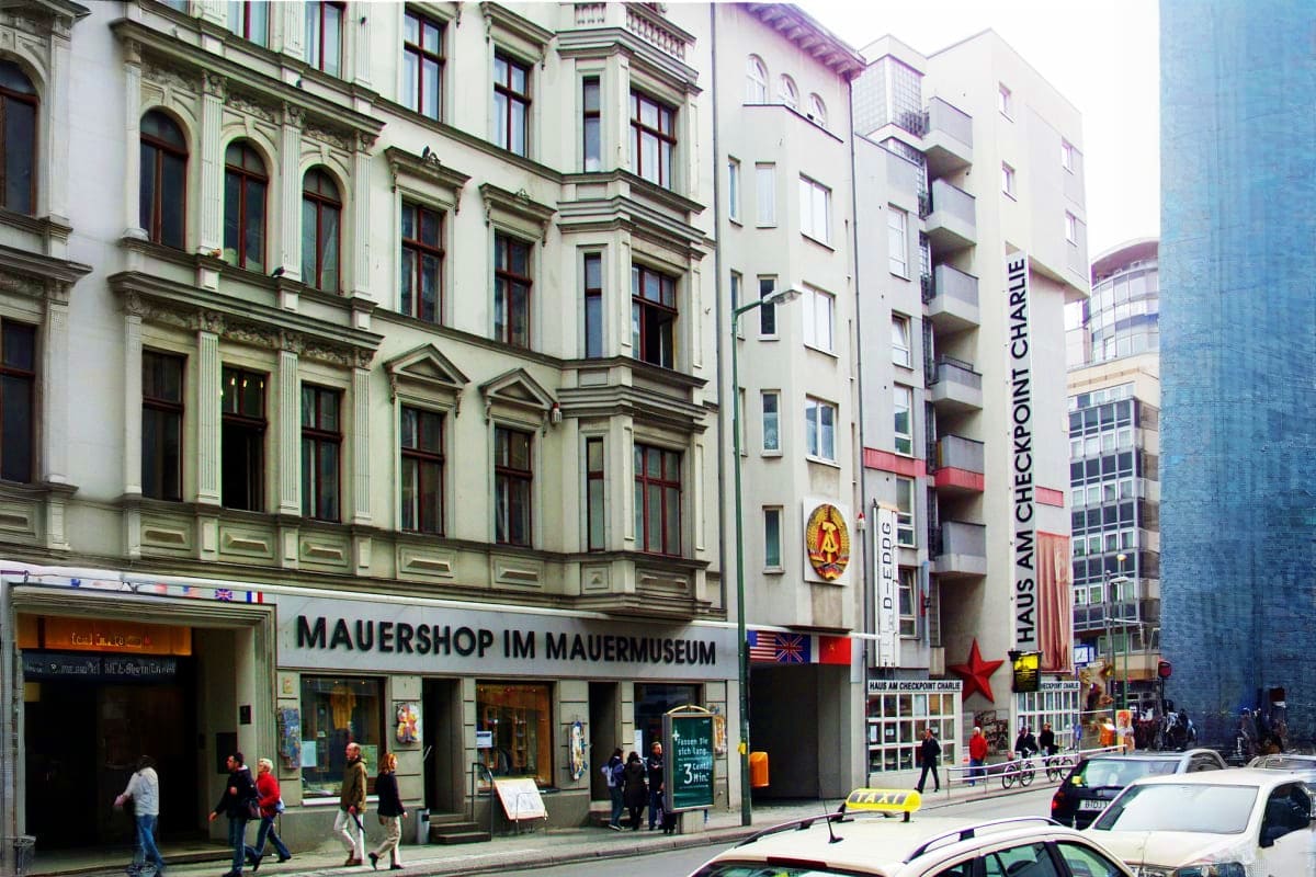 Exterior of Mauershop im Mauermuseum at Checkpoint Charlie in Berlin, with historic buildings and street scene showing museum