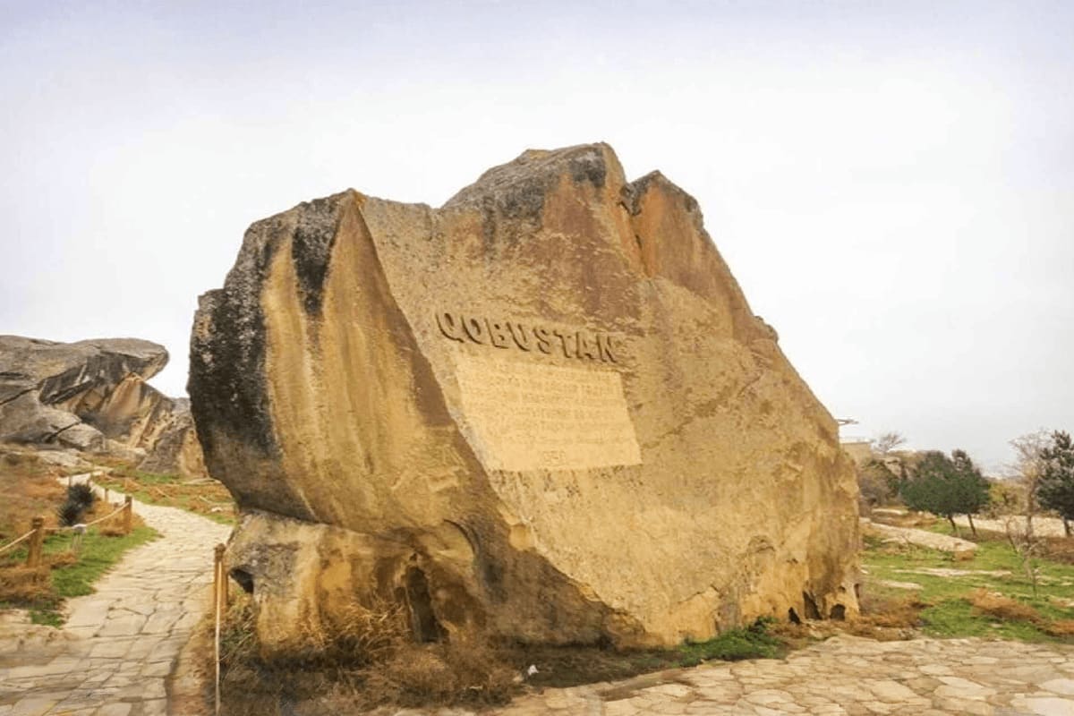 Large ancient rock with carved inscription at Gobustan archaeological site in Azerbaijan