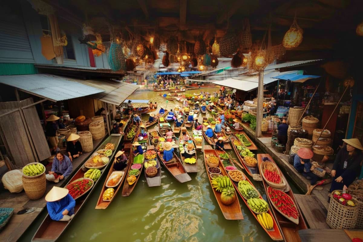 Aerial view of Damnoen Saduak Floating Market with wooden boats loaded with fresh produce, tropical fruits, and vegetables on