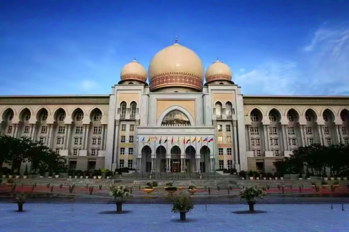 Grand mosque with cream-colored domes and Islamic architecture in Putrajaya, Malaysia's federal administrative center