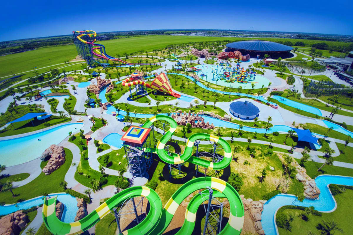 Aerial view of VinWonders theme park showing colorful water slides, lazy rivers, pools, and landscaped grounds surrounded by 