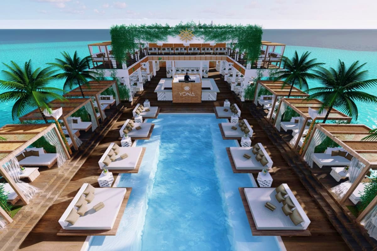 Yona Beach Club Aerial view of Yona Beach Club showing central swimming pool, loungers, palm trees, oceanfront bar and dining area overlookin