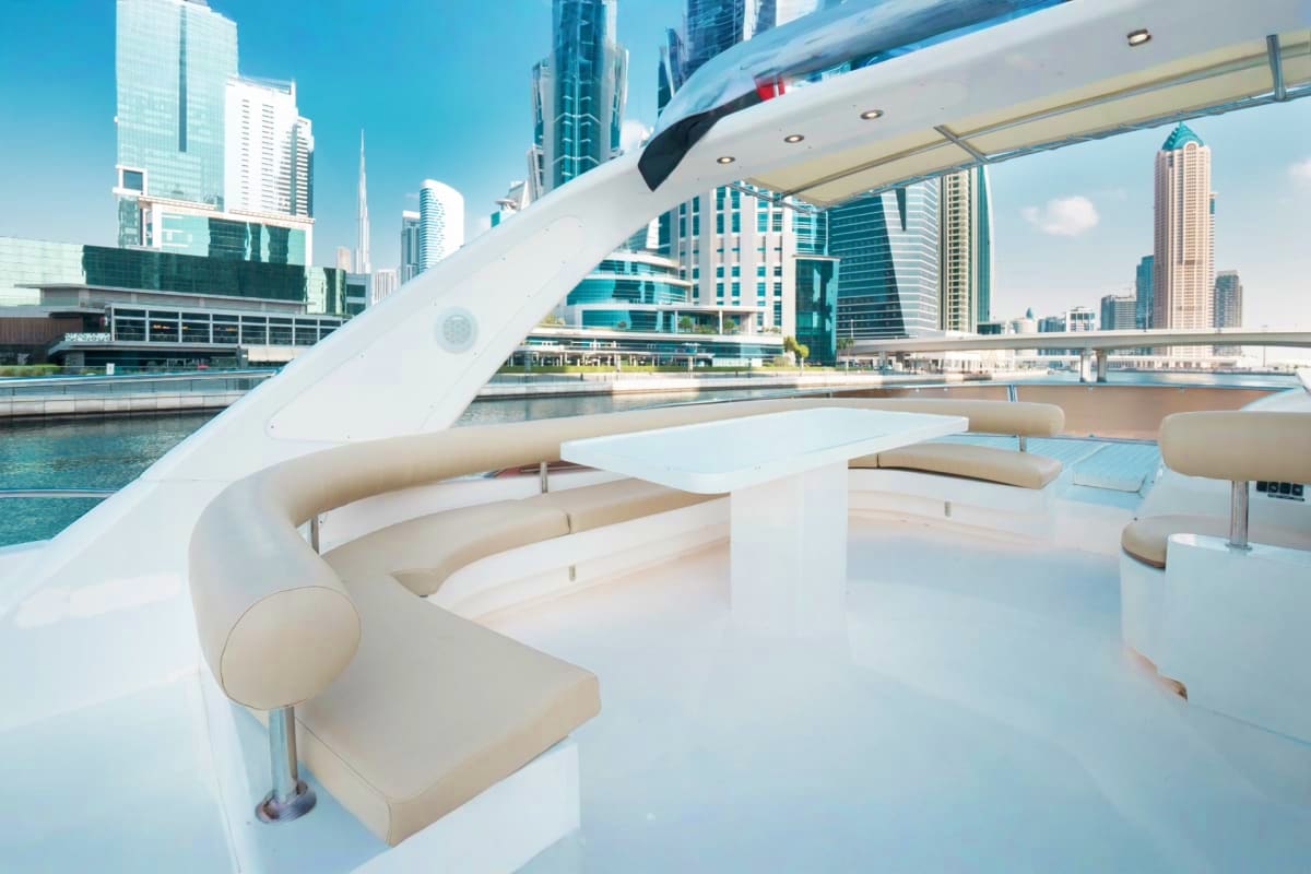 Luxury yacht upper deck with cream seating overlooking Chicago skyline and waterfront