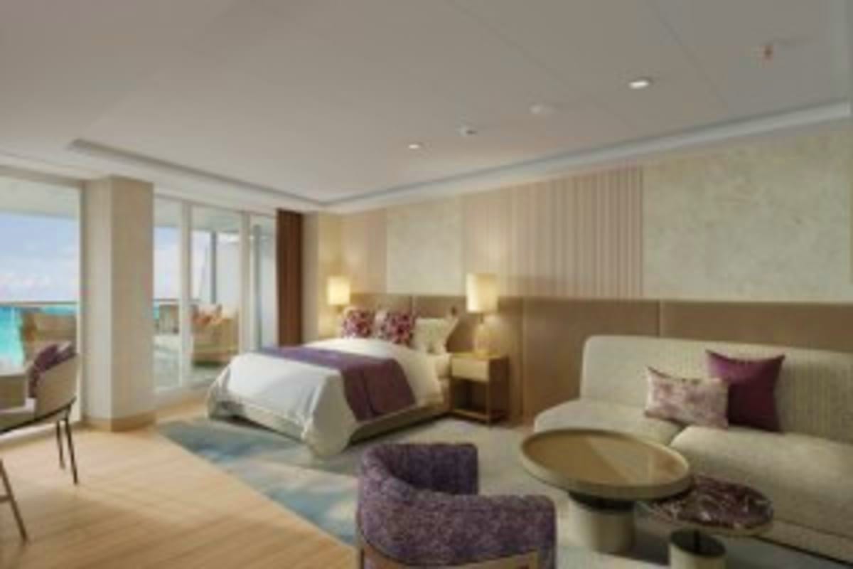 Luxury cruise ship bedroom suite with ocean view balcony, king bed, seating area, and modern furnishings