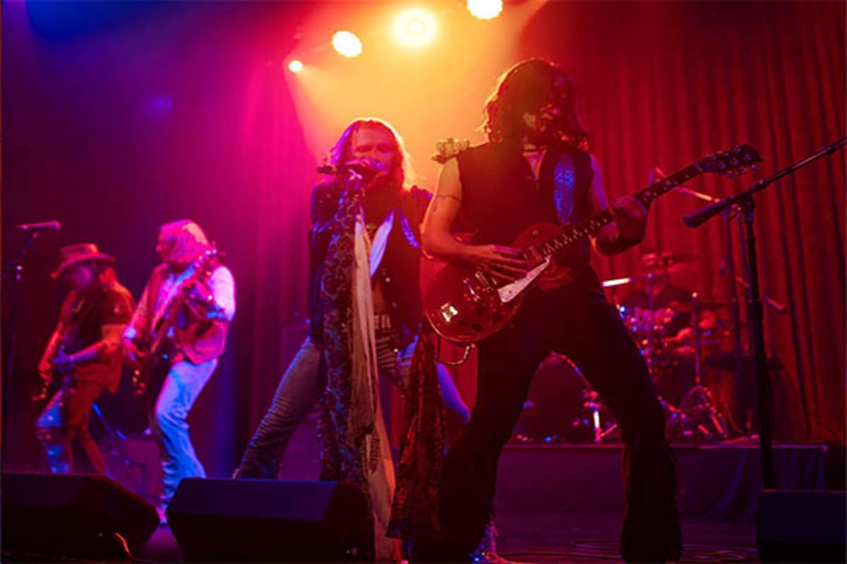 Spectrum of the Seas Asia Cruise Live rock band performing on stage with colorful stage lighting during entertainment event on cruise ship