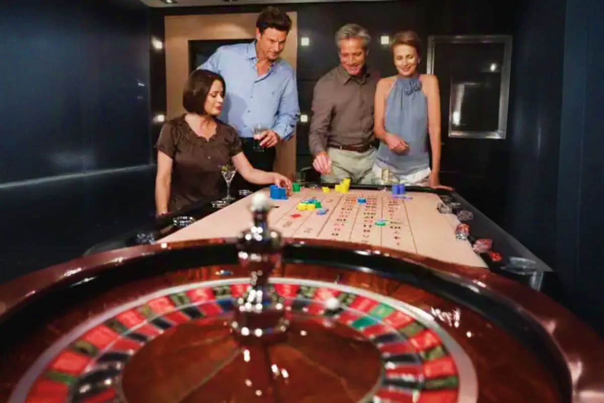 Seabourn Quest Aegean Gems Cruise Four adults playing roulette at a casino table on a cruise ship