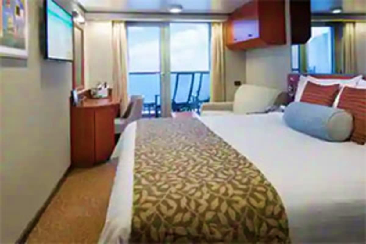 Eurodam Alaskan Explorer Voyage Luxurious cruise ship stateroom with queen bed, ocean view balcony, wood furnishings, and flat-screen TV