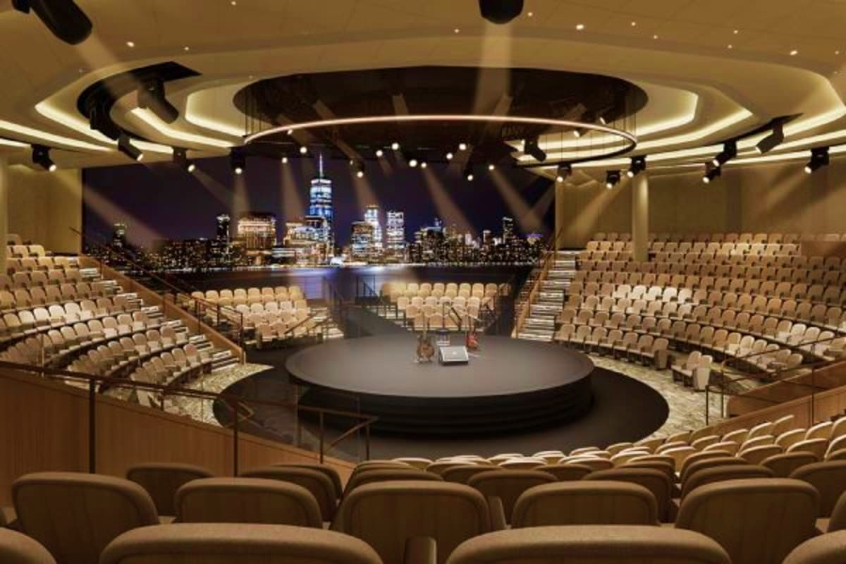Sun Princess Greek Isles Escape Modern theater auditorium on Sun Princess cruise ship with circular stage and New York City skyline backdrop visible through