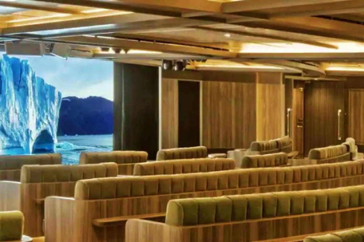 Seabourn Quest Adriatic Greek Treasures Luxury cruise ship dining room with upholstered seating overlooking glacier icebergs and blue water through large windows