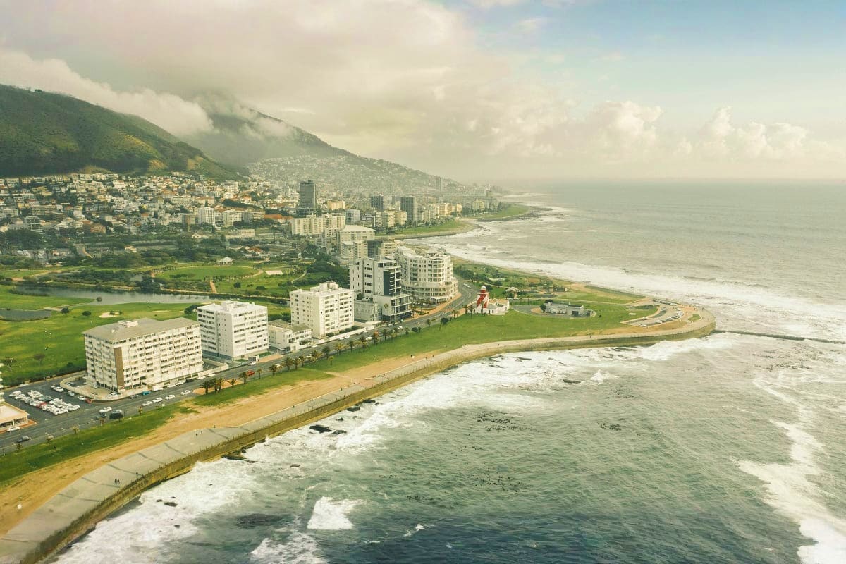 Aerial view of Muizenberg beach and coastal suburbs with mountain backdrop, Cape Town, South Africa