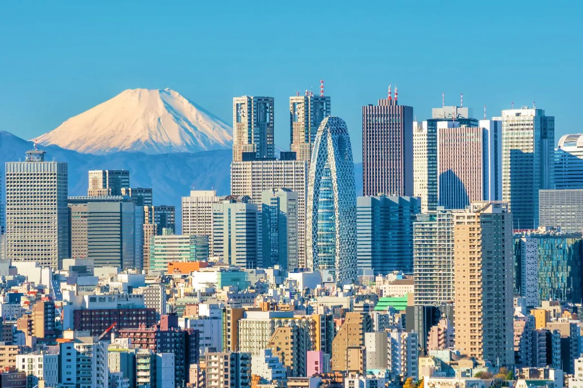 Classic Japan Trio Tokyo skyline with snow-capped Mount Fuji in background and modern skyscrapers under clear blue sky