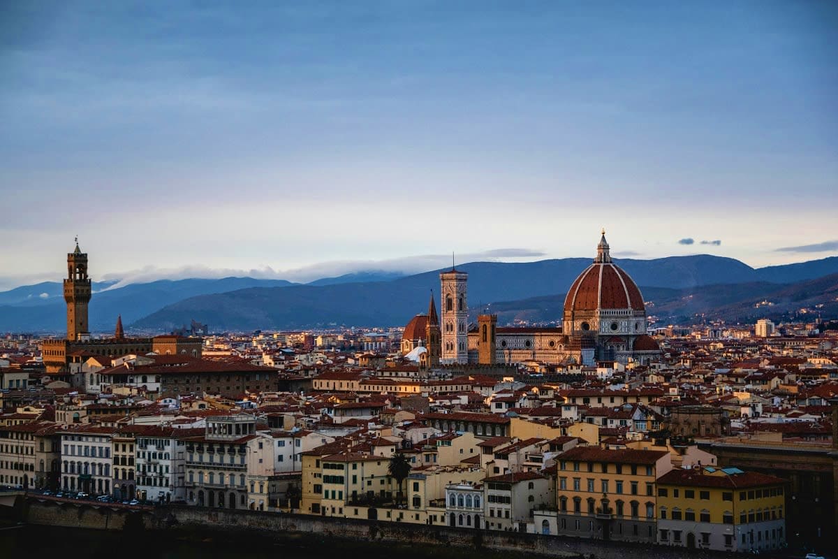Florence skyline with the Duomo cathedral, Campanile bell tower, and Palazzo Vecchio overlooking the Arno River and surroundi