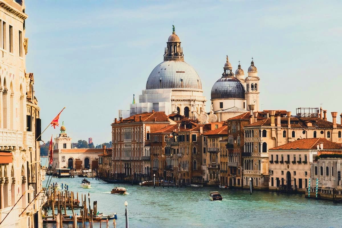 Grand Canal in Venice with Basilica di Santa Maria della Salute dome and historic palazzo buildings along the waterway