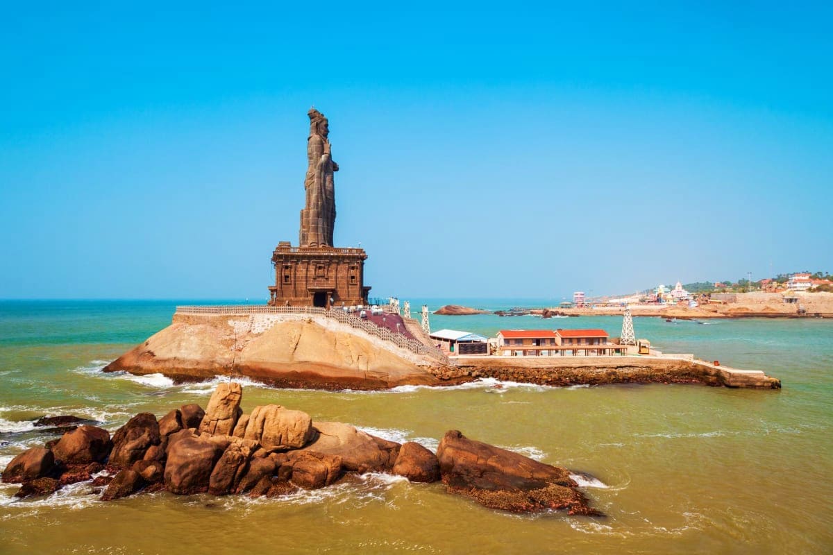 Thiruvalanthira Mahadev Temple statue on rocky island in Arabian Sea, Kanyakumari, Kerala coast with turquoise waters