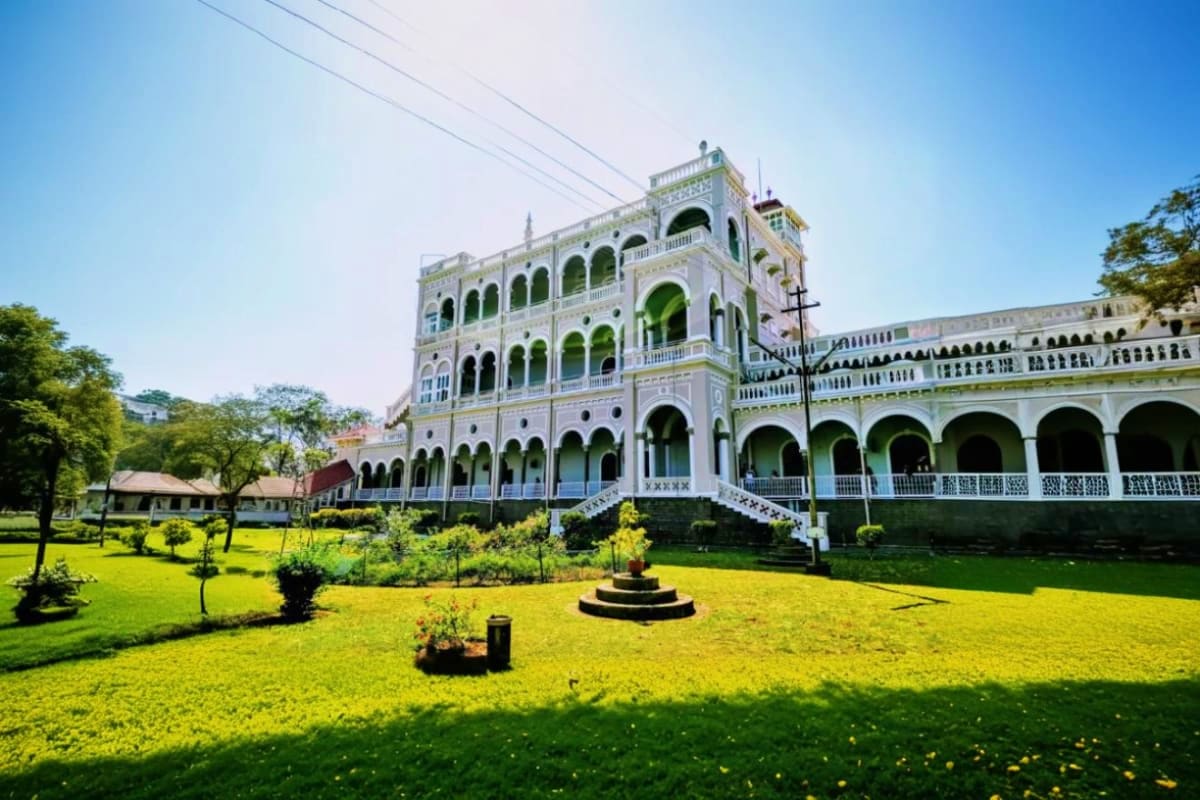 Historic white colonial palace with ornate arches and manicured gardens in Kochi, Kerala, South India