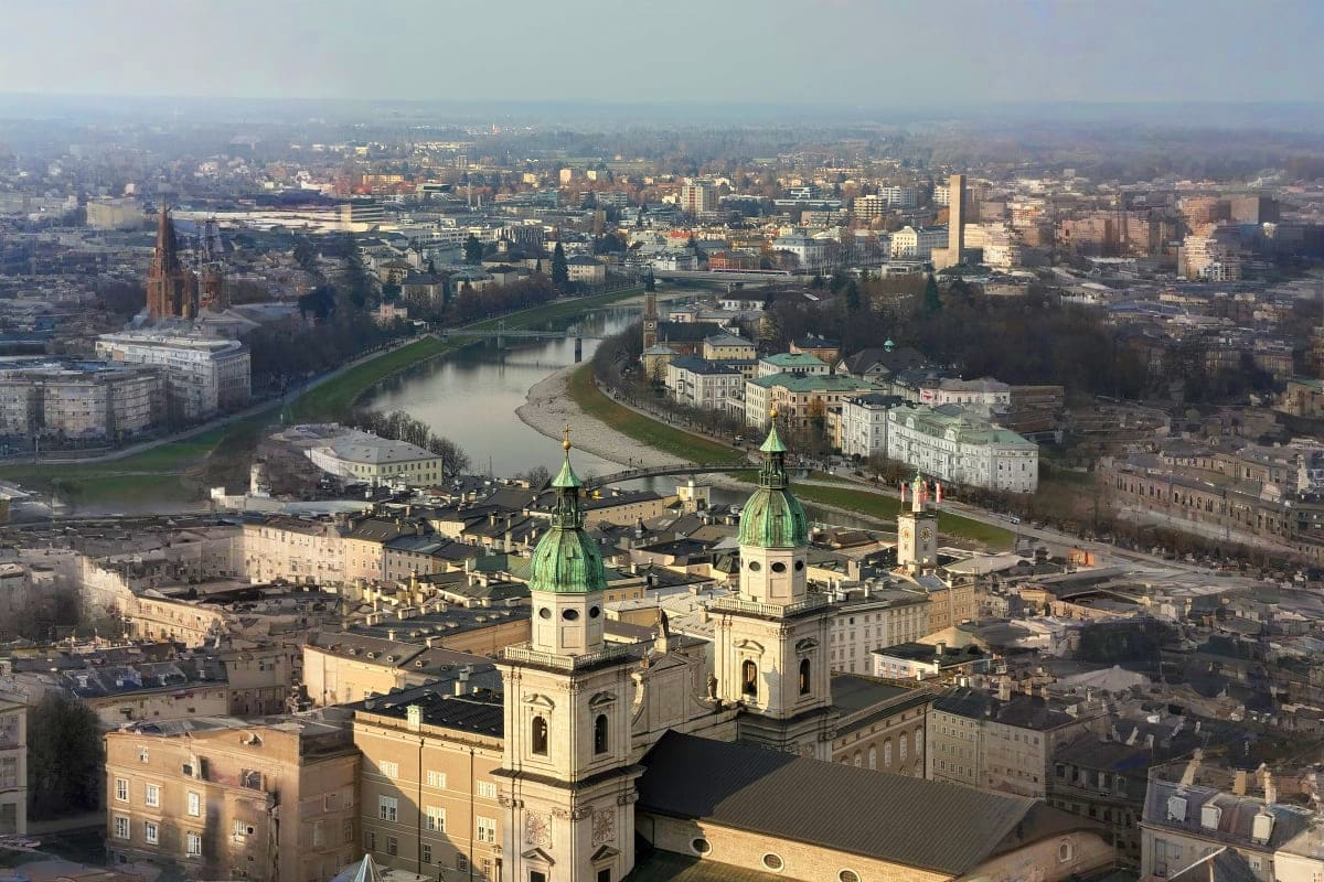Aerial view of Passau, Germany showing the Dom St. Stephan cathedral with green copper domes overlooking the Inn River and ci